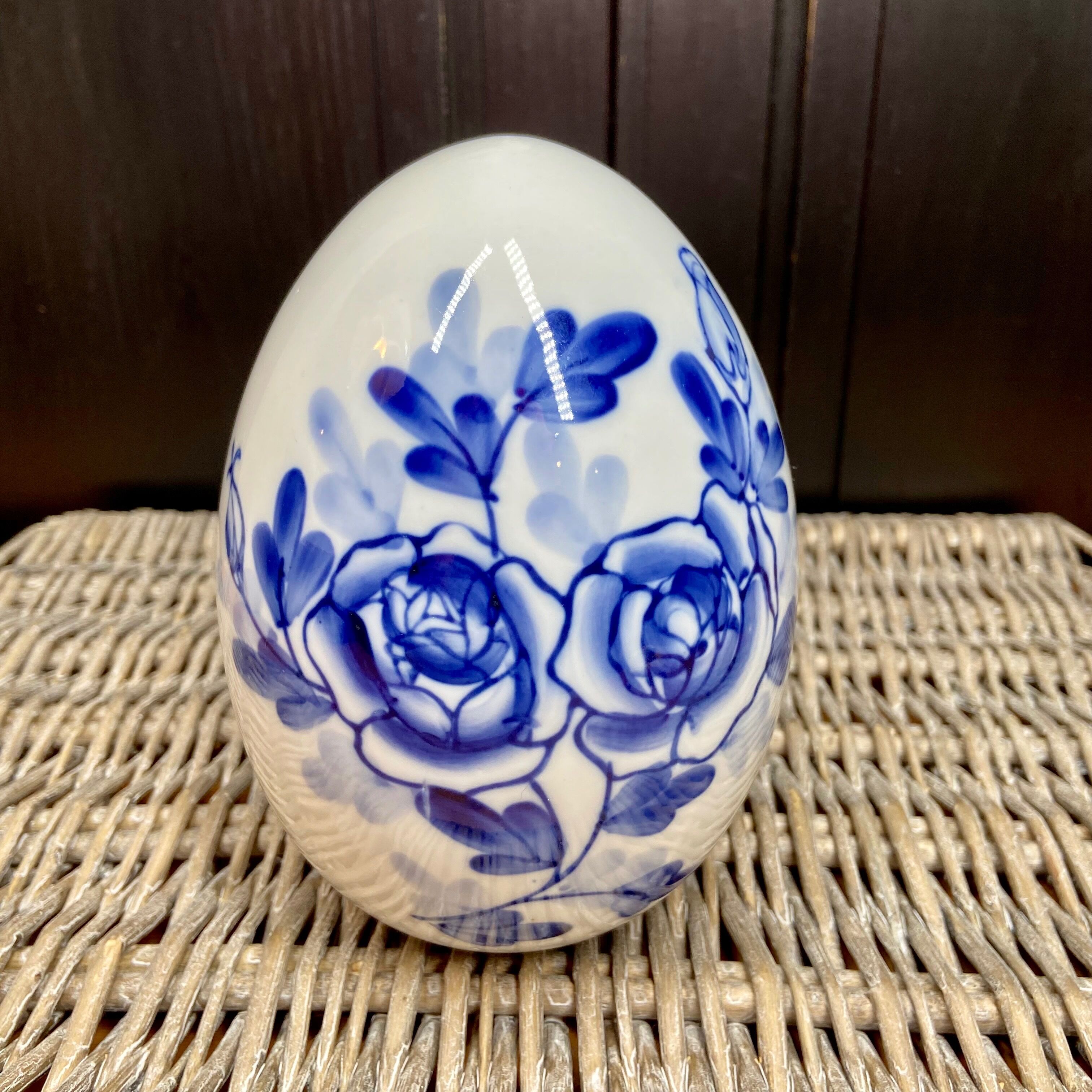 Decorative egg in white porcelain decoration blue flowers