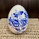 Decorative egg in white porcelain decoration blue flowers