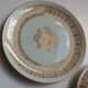 Solitaire tea cup, saucer, and dessert plate in white and gold.