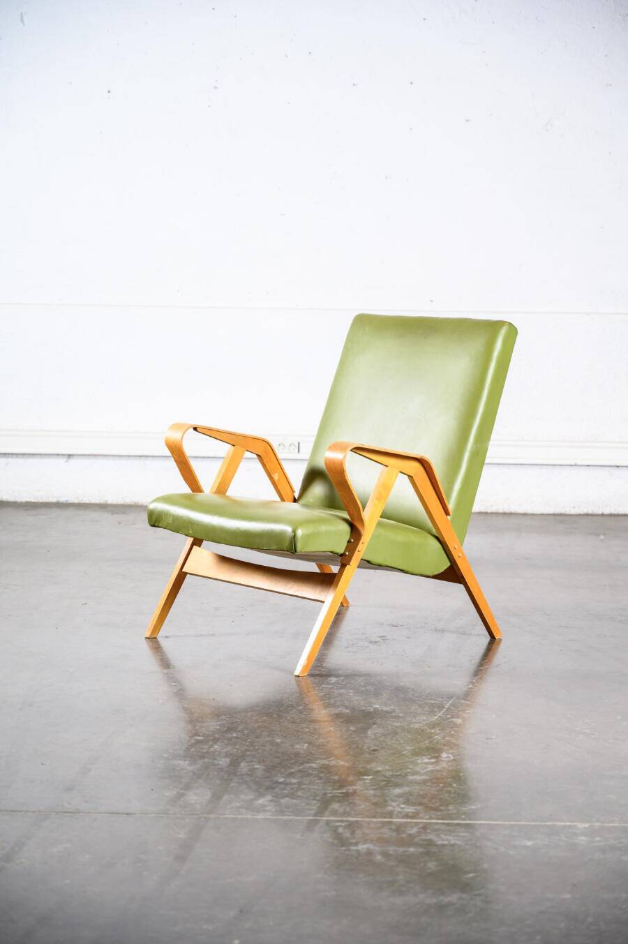 Fauteuil en skaï vert
