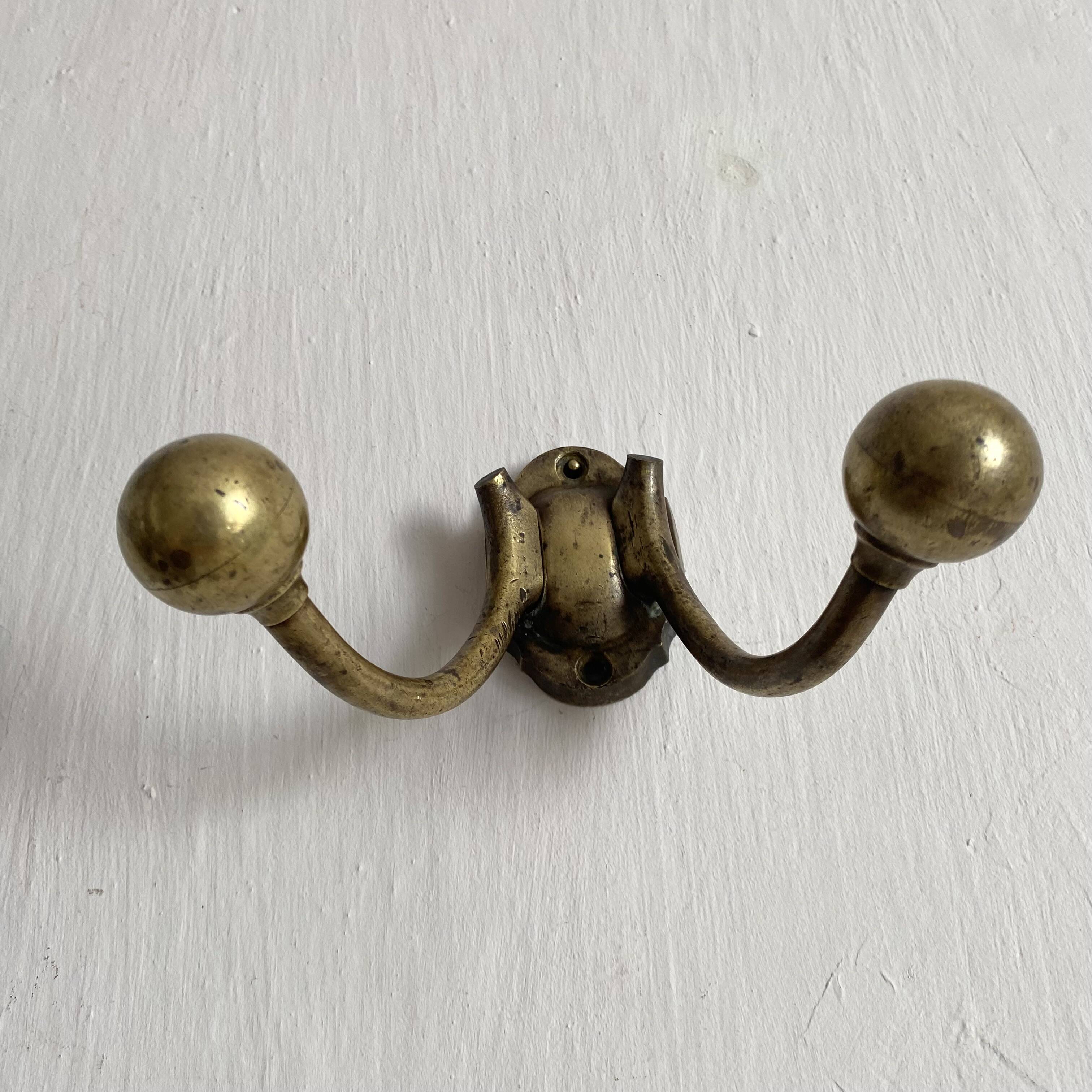 Antique double coat hook in solid brass