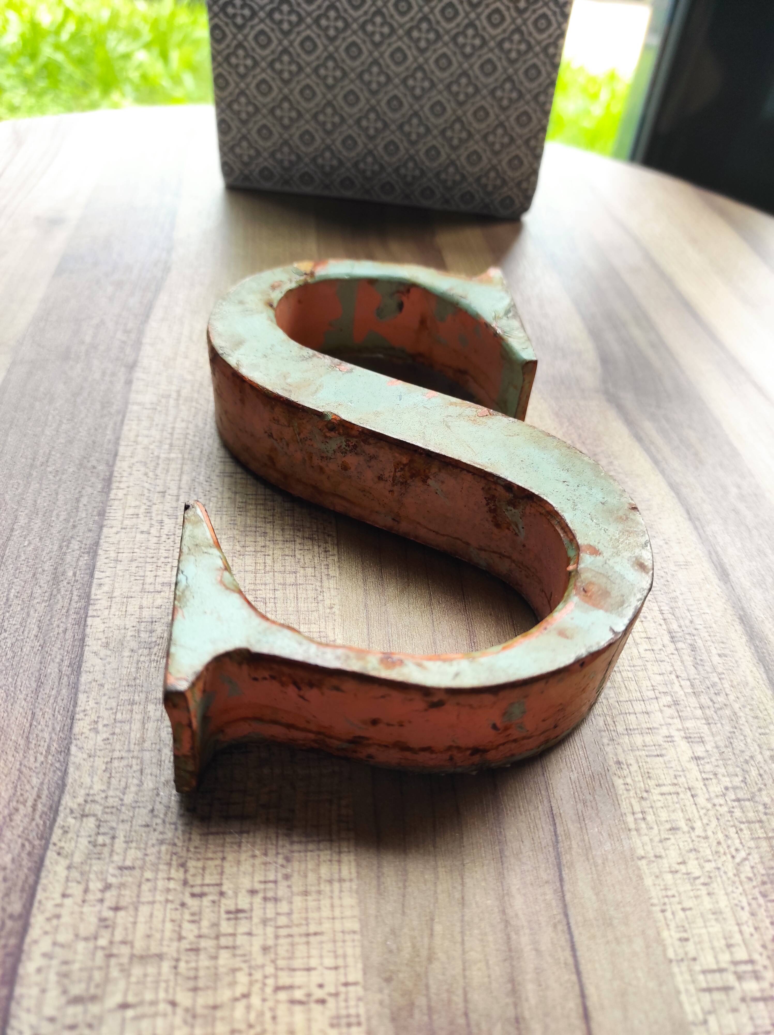 Old sign letter "S" in patinated metal