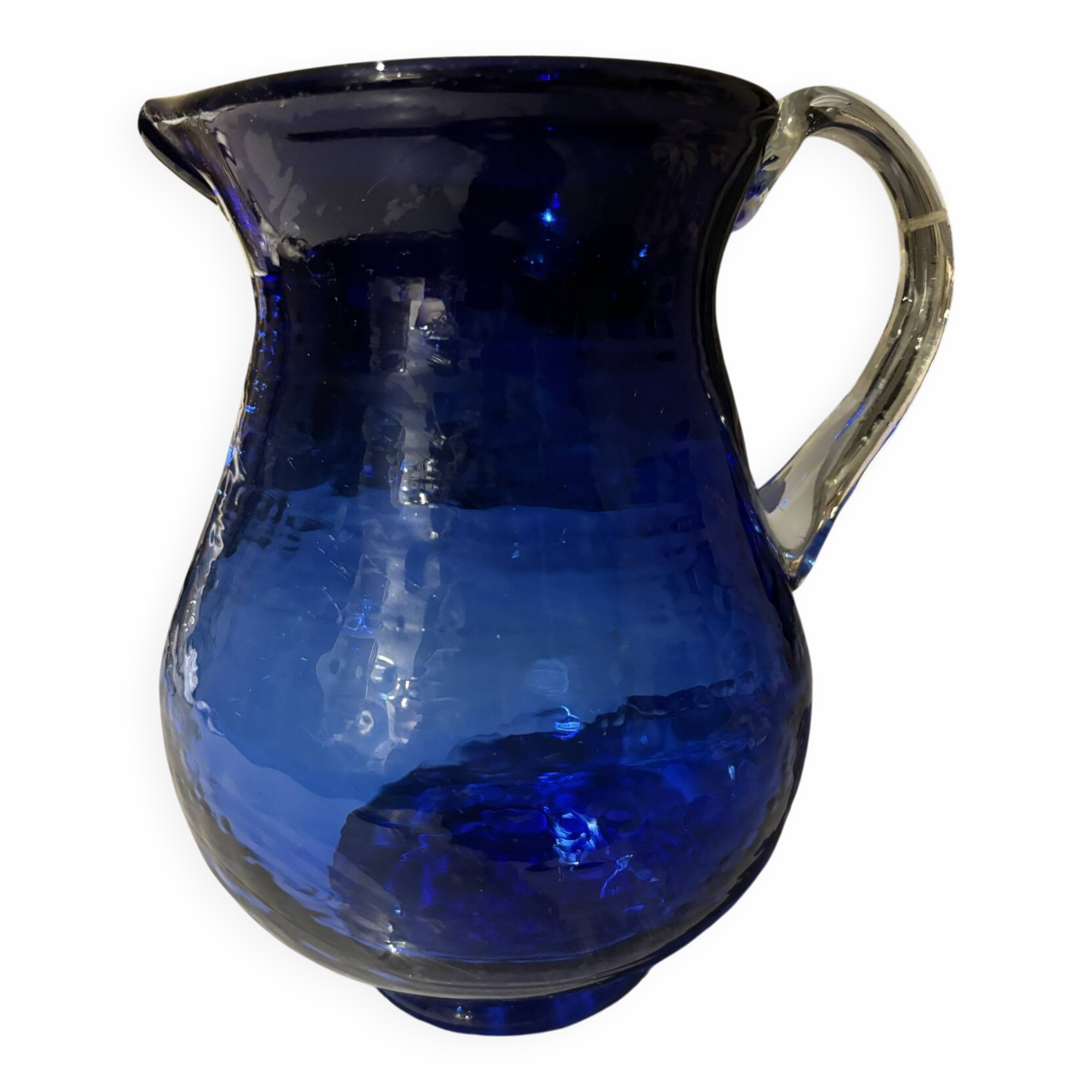 Vintage cobalt blue blown glass jug with a transparent handle.