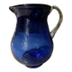 Vintage cobalt blue blown glass jug with a transparent handle.