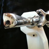 Old ceramic bathroom shelf with 2 chrome bronze faucets