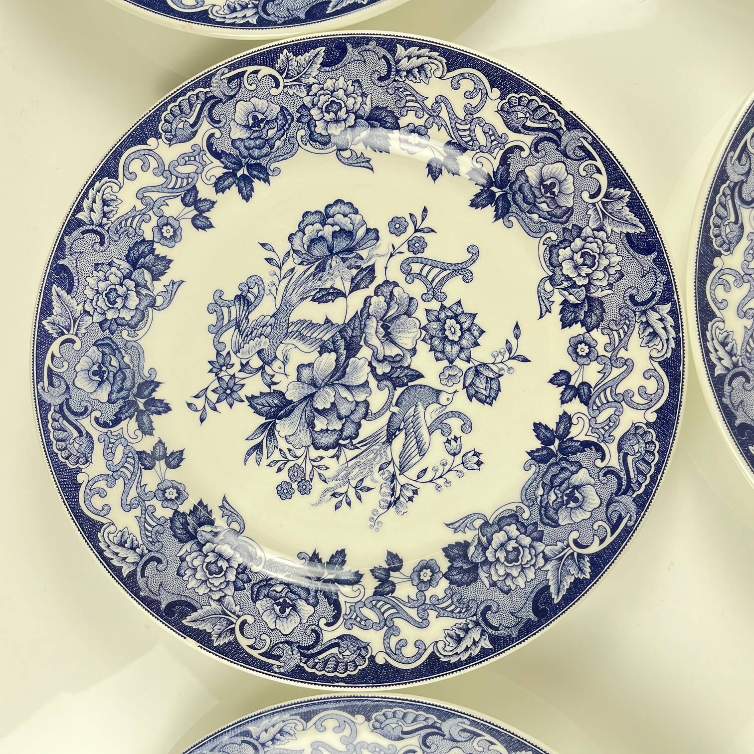Set of 8 blue earthenware dinner plates with floral and bird decoration, 20th century
