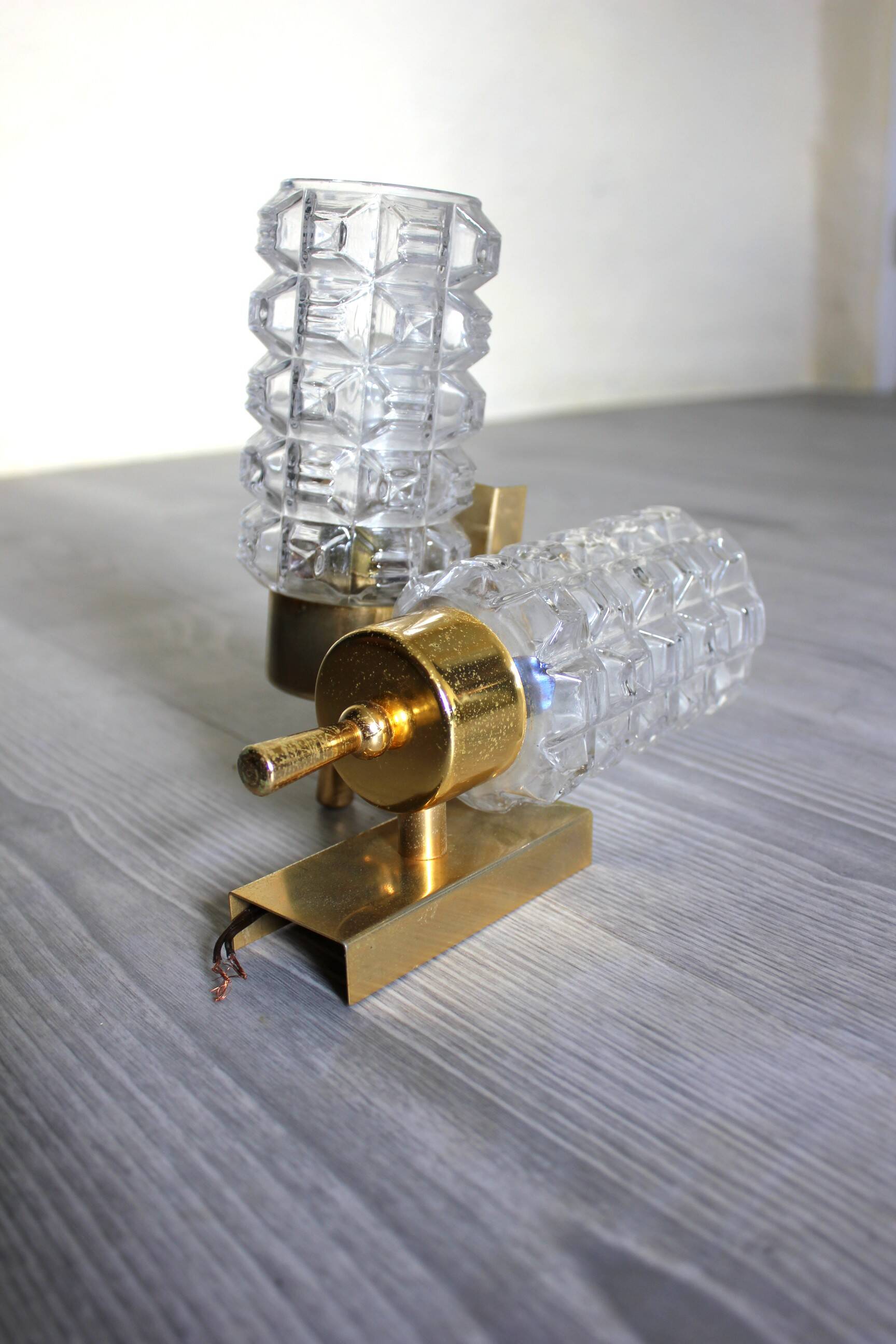 Pair of vintage wall sconces in gilded brass with moulded glass.