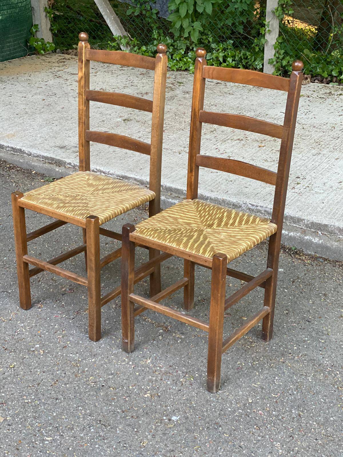 2 solid wood and straw chairs