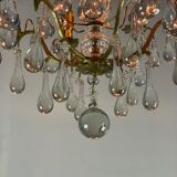 Gilded bronze chandelier trimmed with drop-shaped stamps