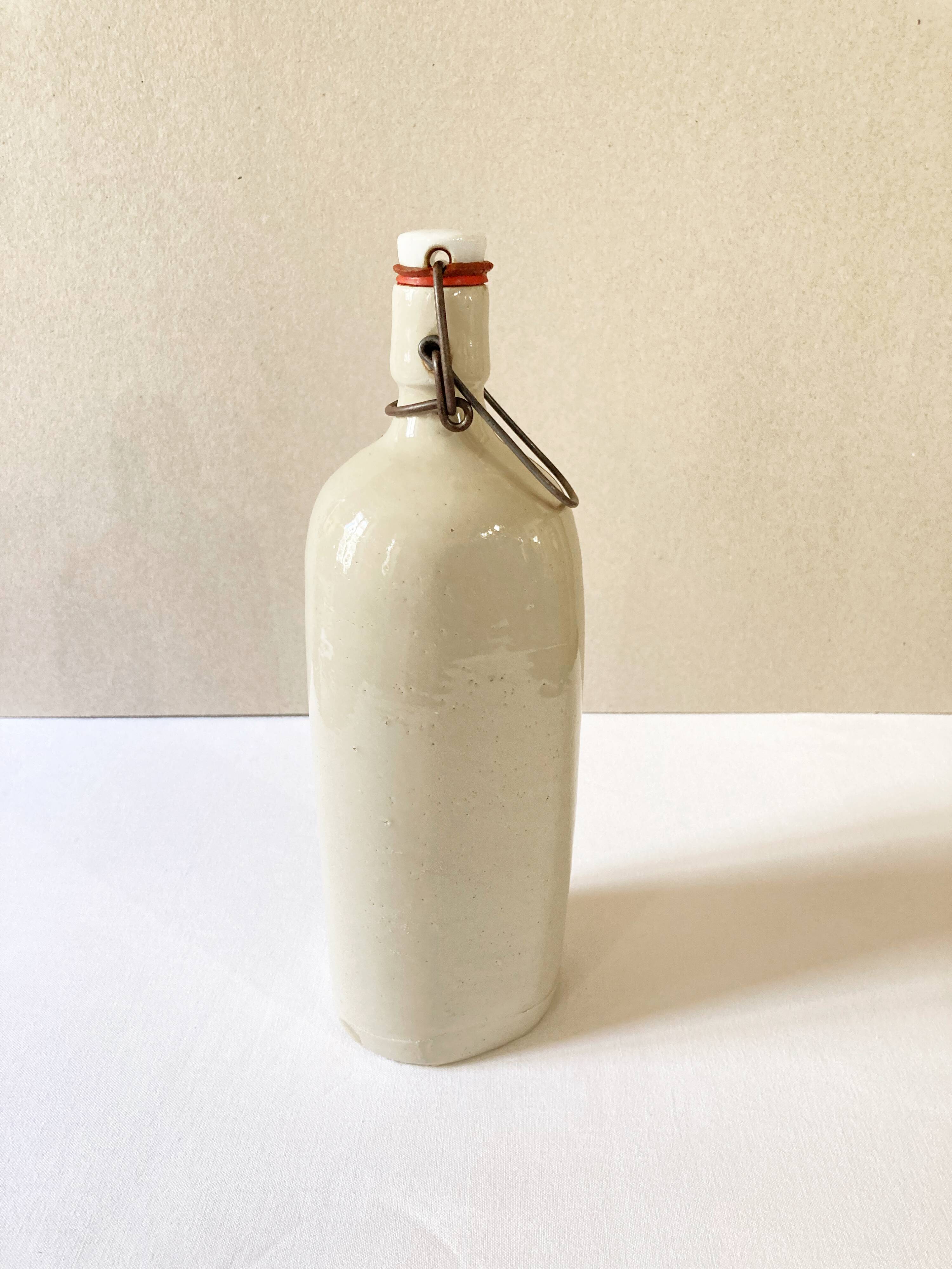 Old light gray enamelled stoneware hot water bottle