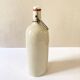 Old light gray enamelled stoneware hot water bottle
