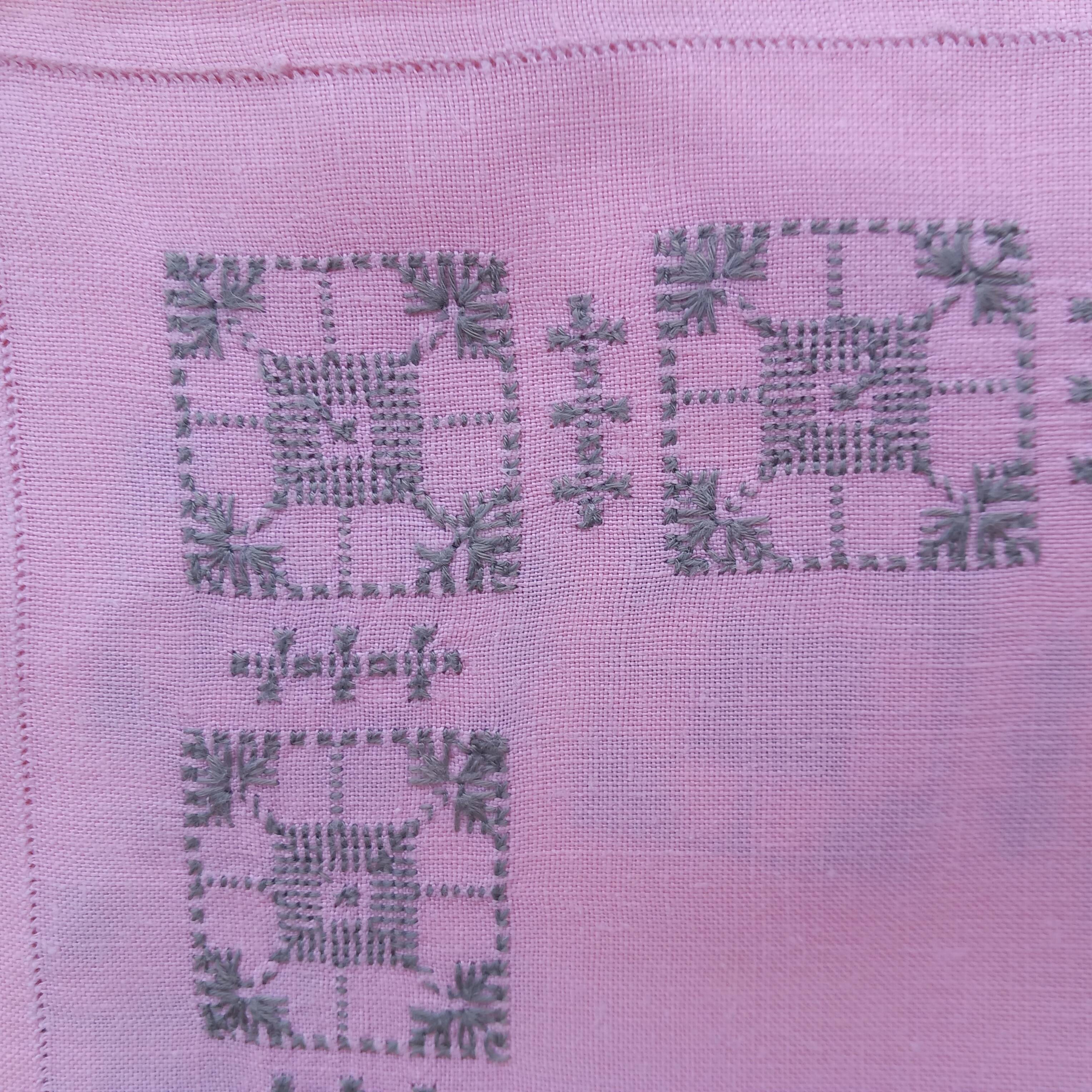 Large vintage linen tablecloth embroidered in pink and 12 matching napkins.