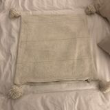 White cushion cover with pom poms