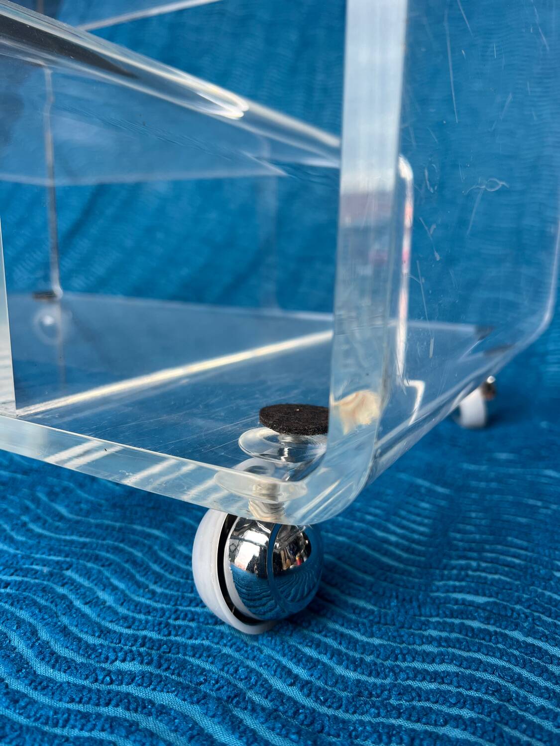 Translucent plexiglass storage drawer/cabinet on wheels.