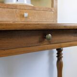 Antique writing table in the Napoleon III style with turned wooden legs.