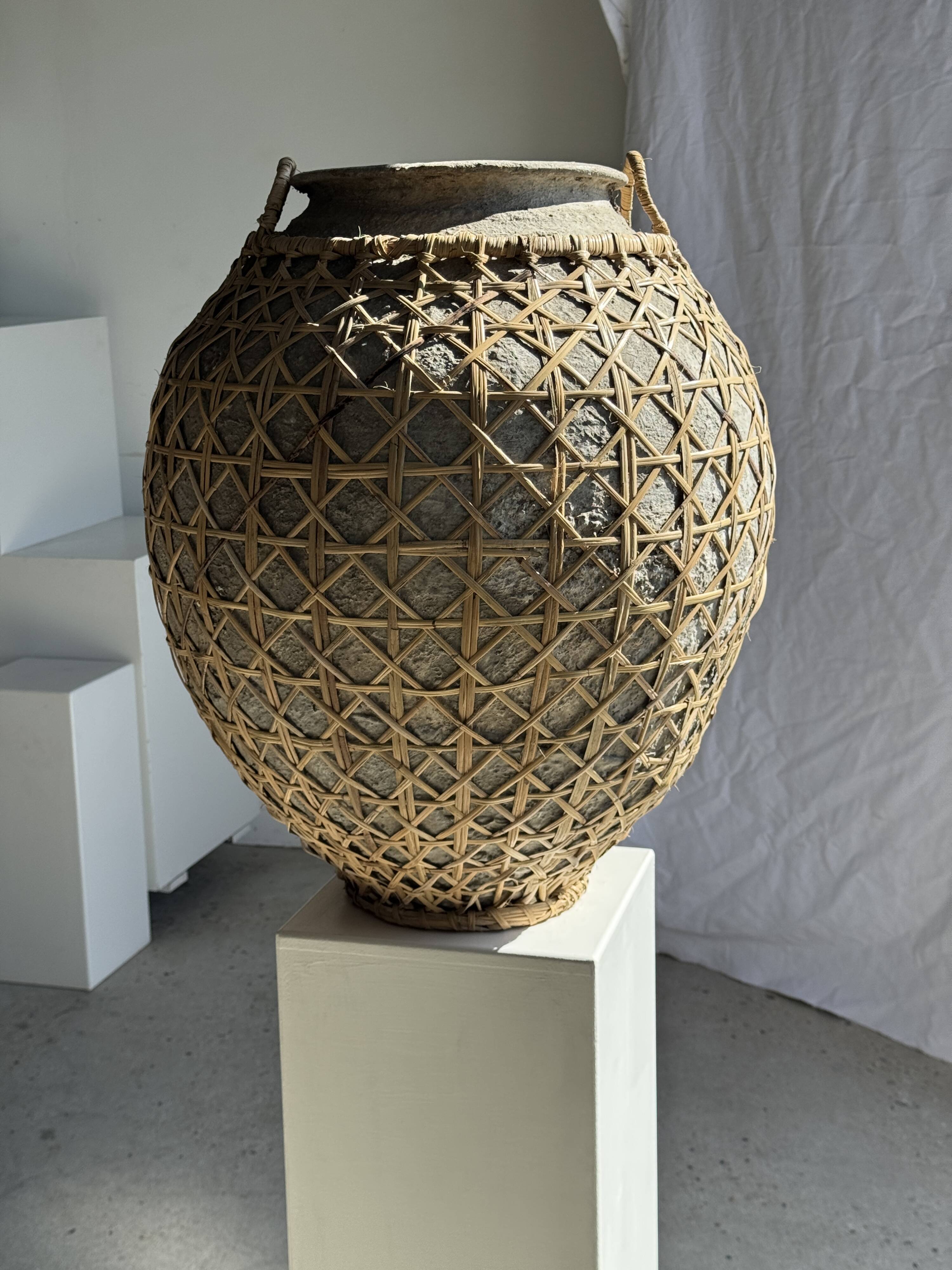 Immense light grey antique-style pot with a crosshatch lid and handles.