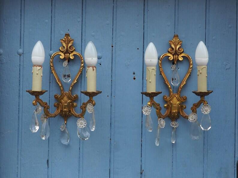 French antique Louis XV style twin arm wall sconces in bronze with crystals.