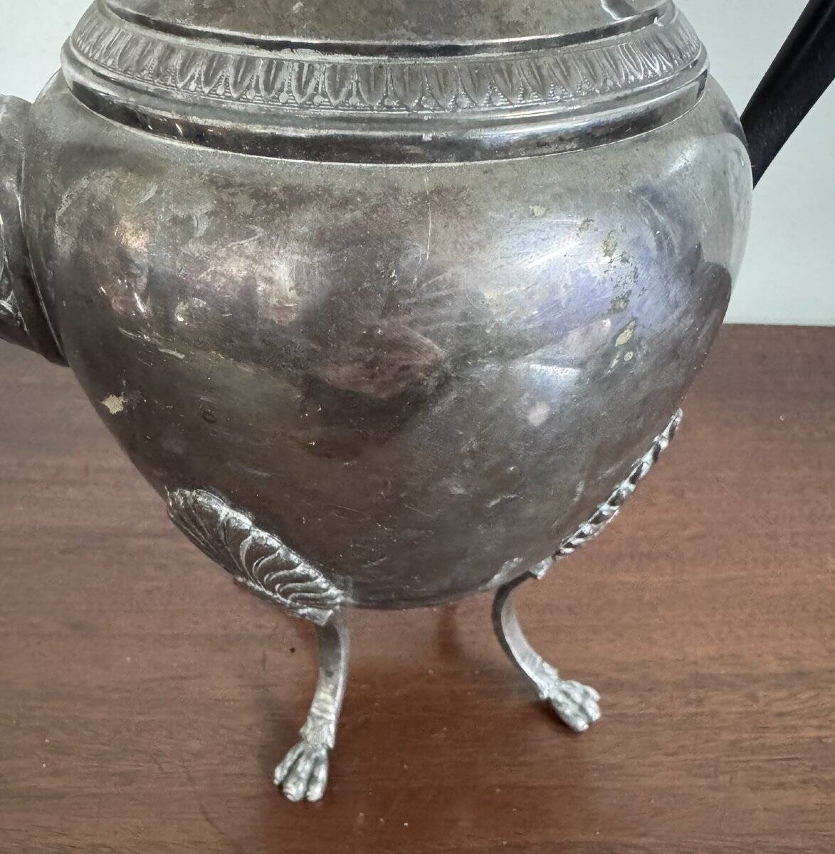 Empire style silver-plated verseuse, resting on three sculpted feet.