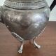 Empire style silver-plated verseuse, resting on three sculpted feet.
