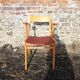 Old wooden and red leatherette bridge chair