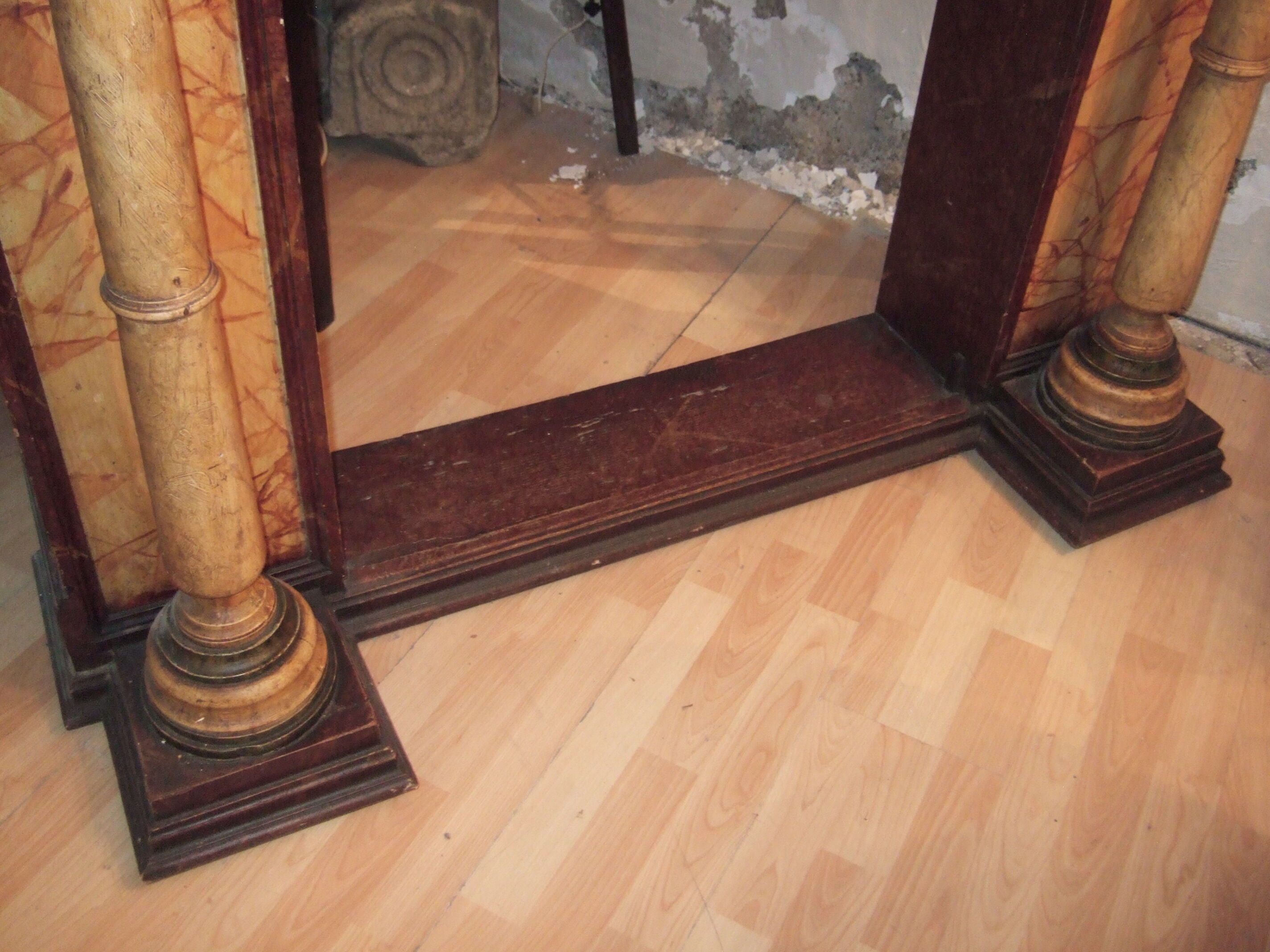 19th century wooden fireplace, faux marble paint. Can act as a console.