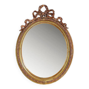 Wear consistent with age and use Wood and gilded plaster "Noeud d'Amour" Oval mirror