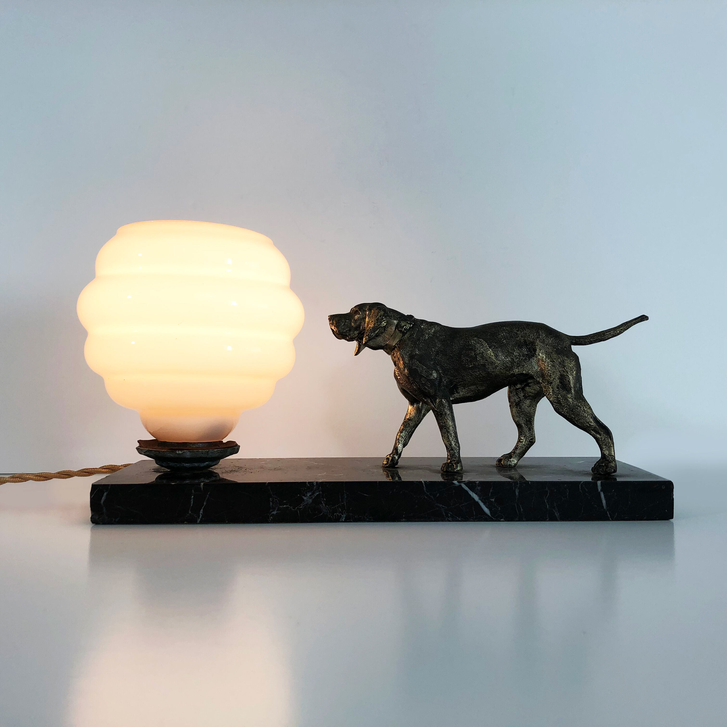 Lamp, Art Deco night light, dog on black marble base, pink globe. Year 30