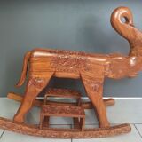Decorative rocking elephant in carved exotic wood.