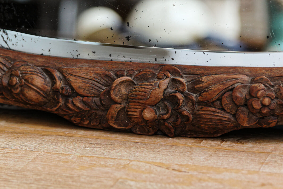 Beveled mirror in carved wood