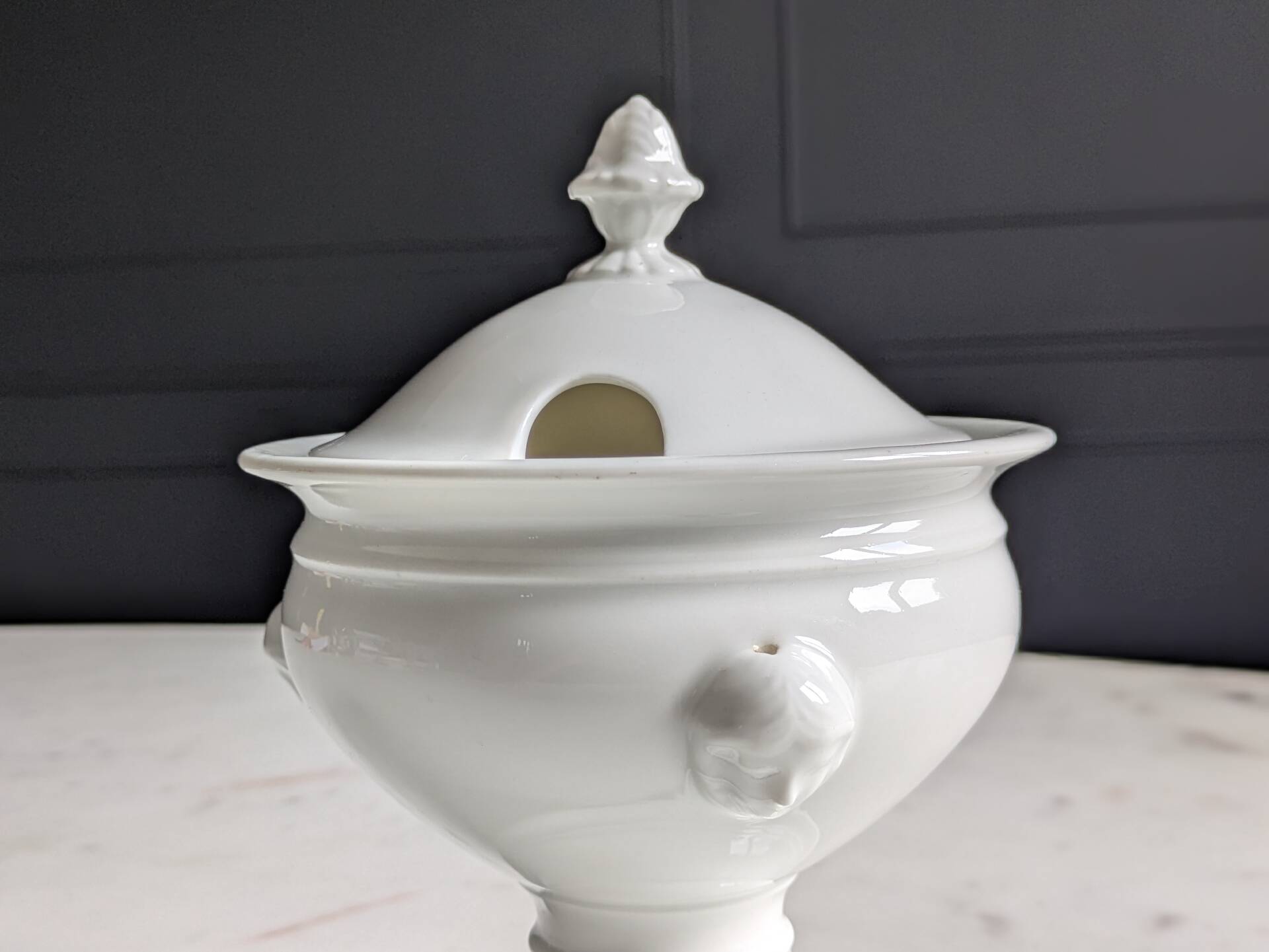 White porcelain confiturier with lion paws and masks. 19th century.