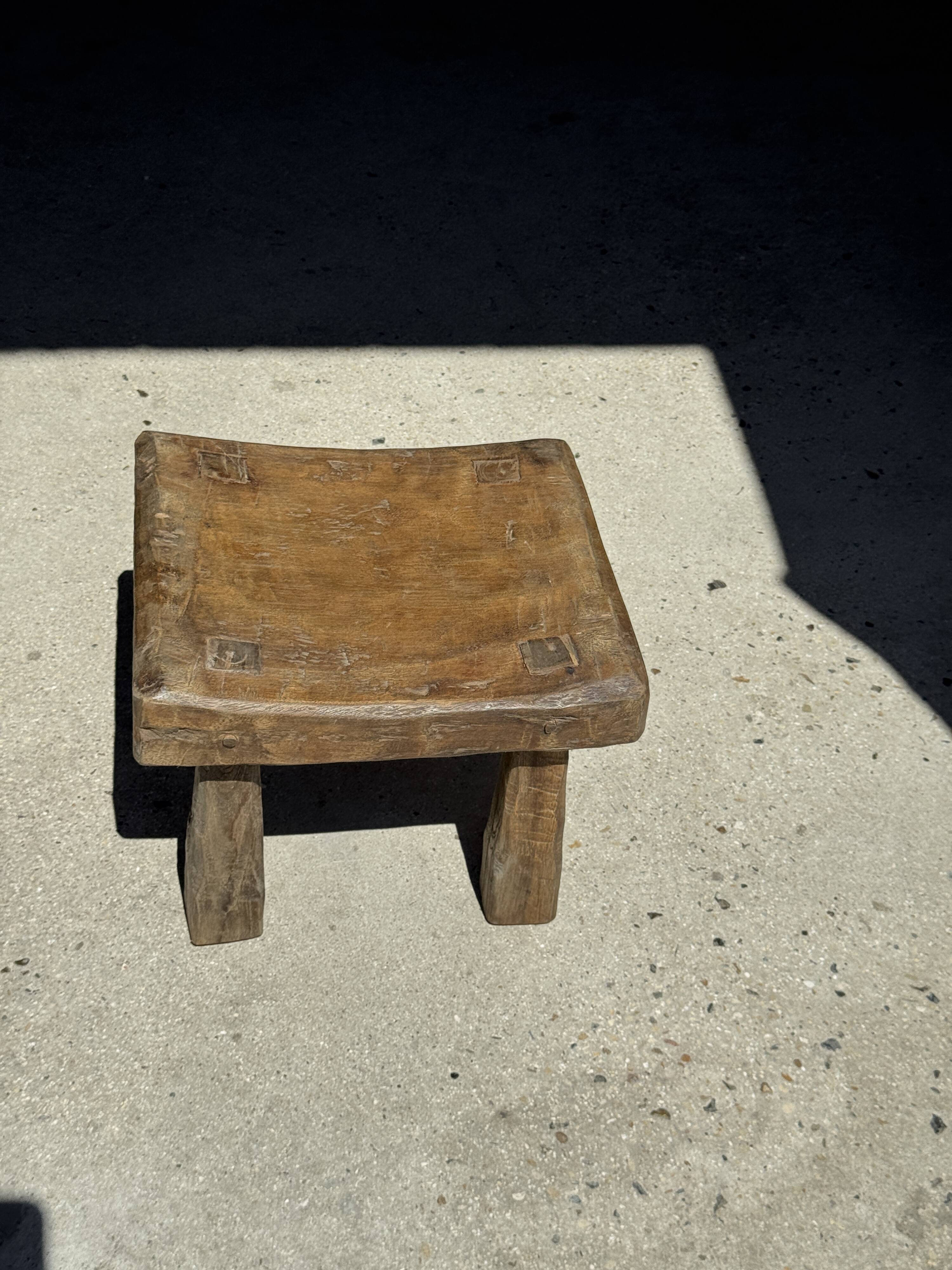 Small stool, square solid teak side table with a curved seat.