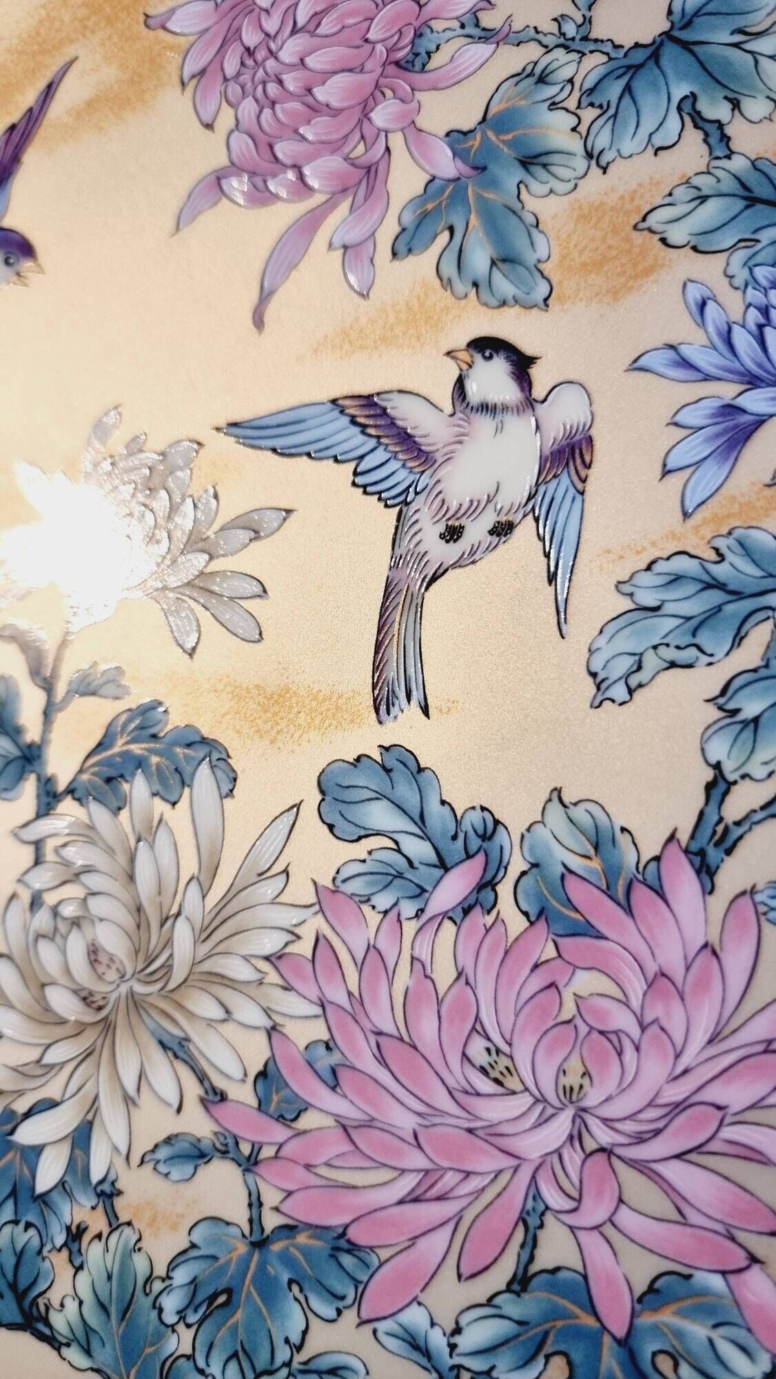 Vintage Japanese decorative plate with chrysanthemum and bird patterns.