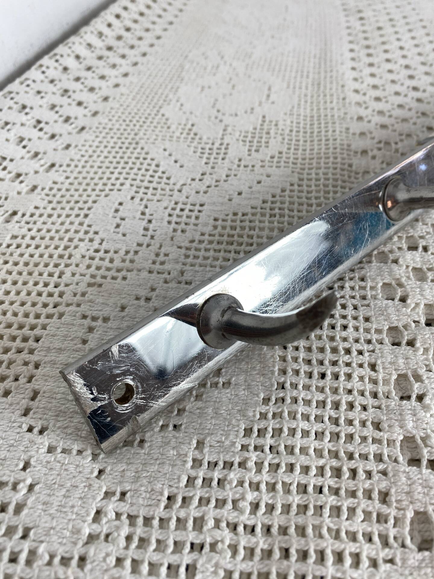 Stainless steel butcher's hook, known as a "wolf tooth bar."