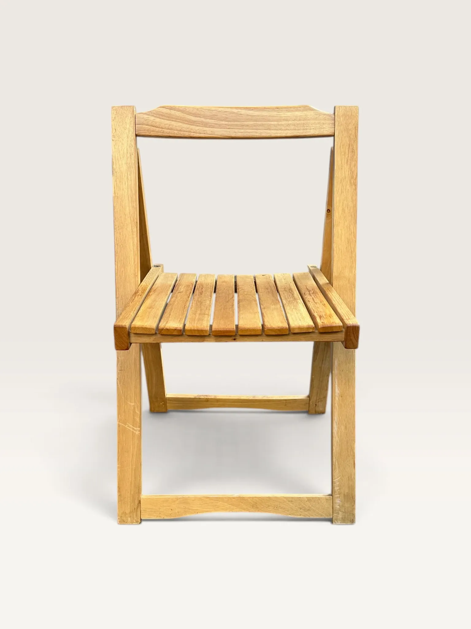 Blonde wooden folding chair in the style of Aldo Jacober.