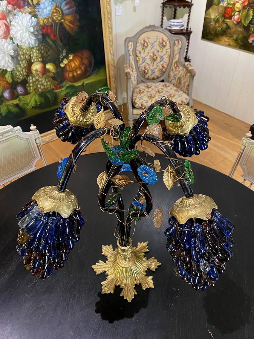 Table lamp with four light arms and globes shaped like bunches of grapes.