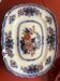 Large hollow dish in fine earthenware with Japanese decoration.