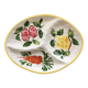 Serving platter decorated with fruits and vegetables.