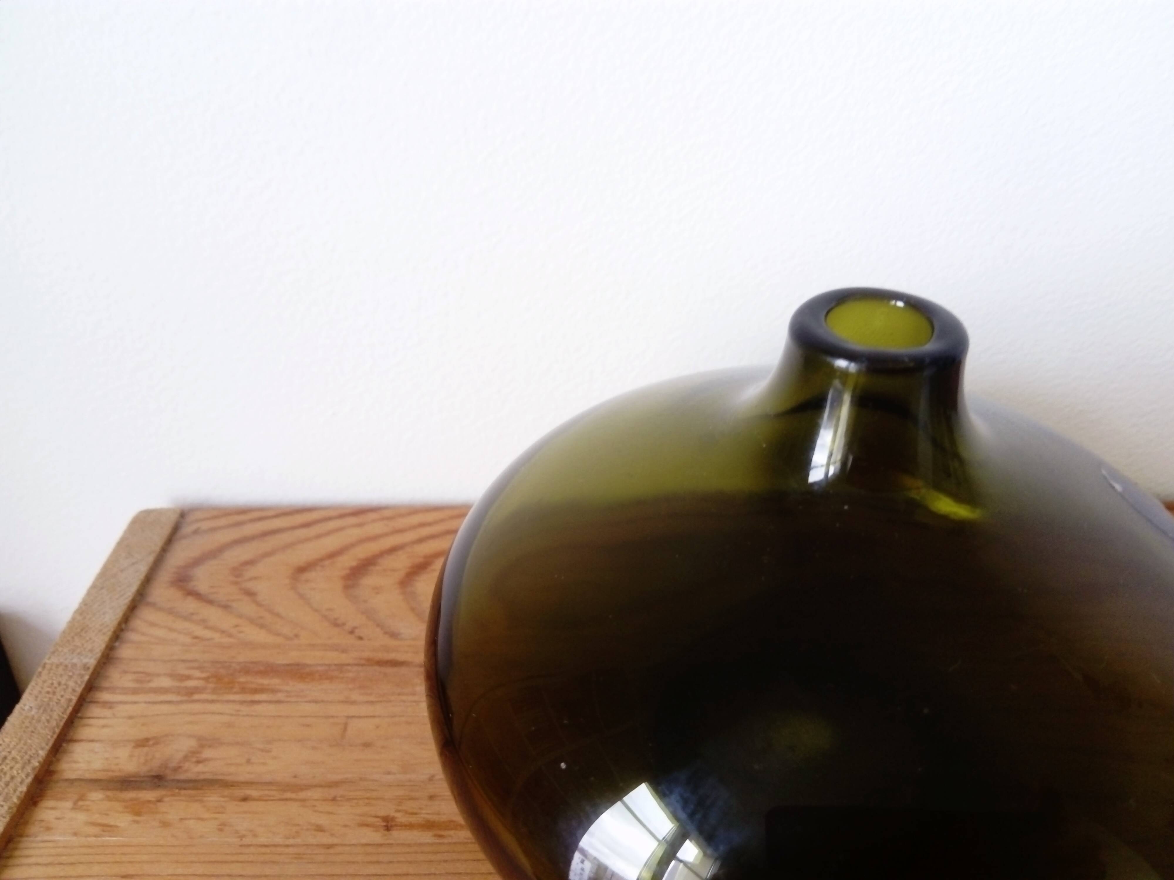 Small dark green handmade glass ball vase