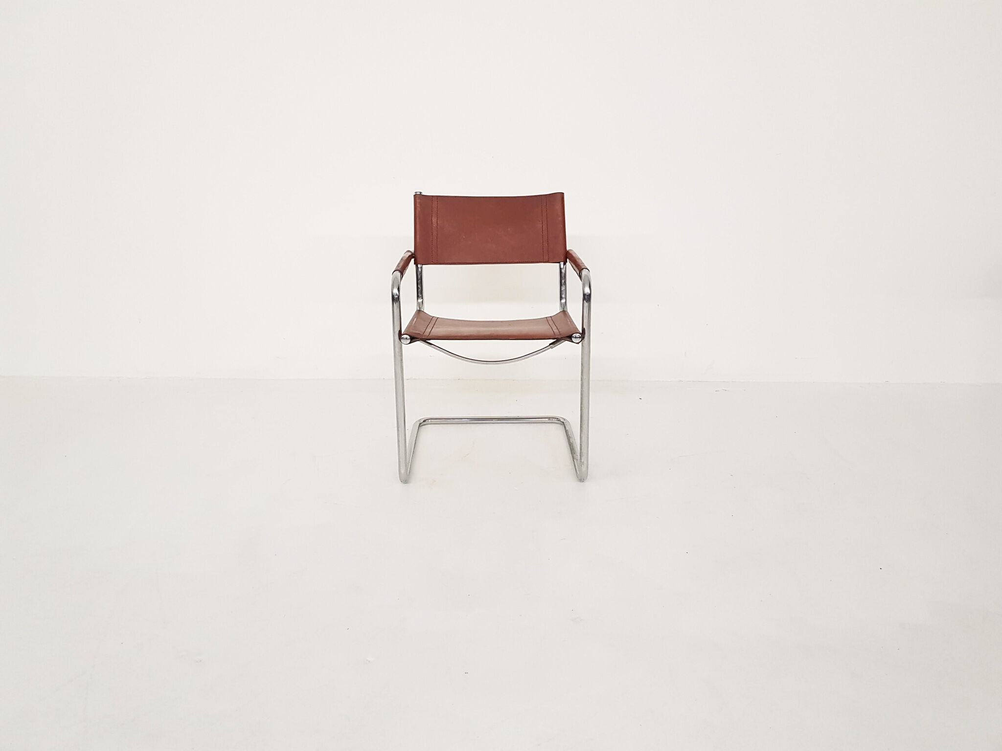 Tubular dining chair with arm rests, 1970's