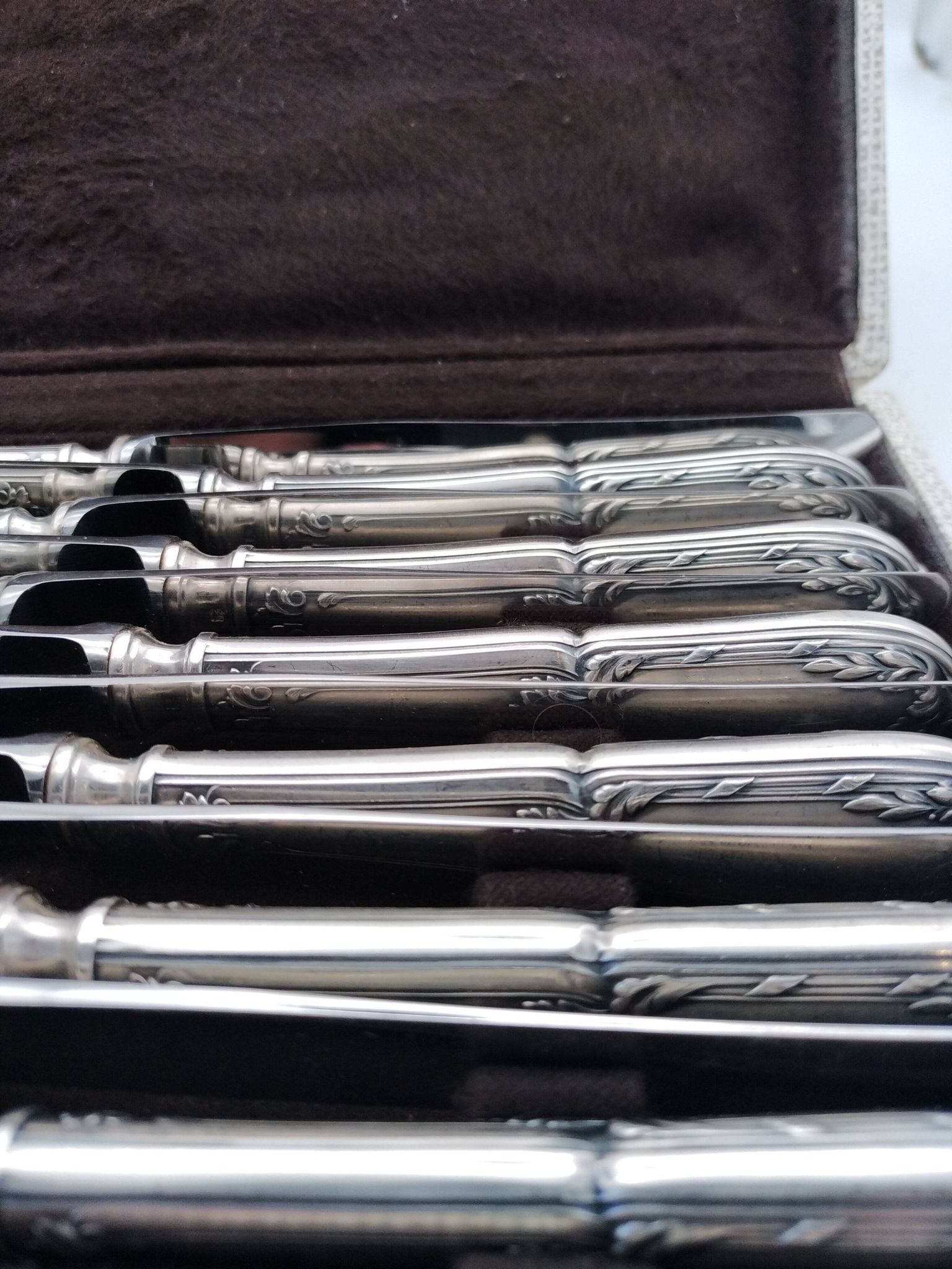 Set of 12 sfam knives in silver metal and stainless steel blades.