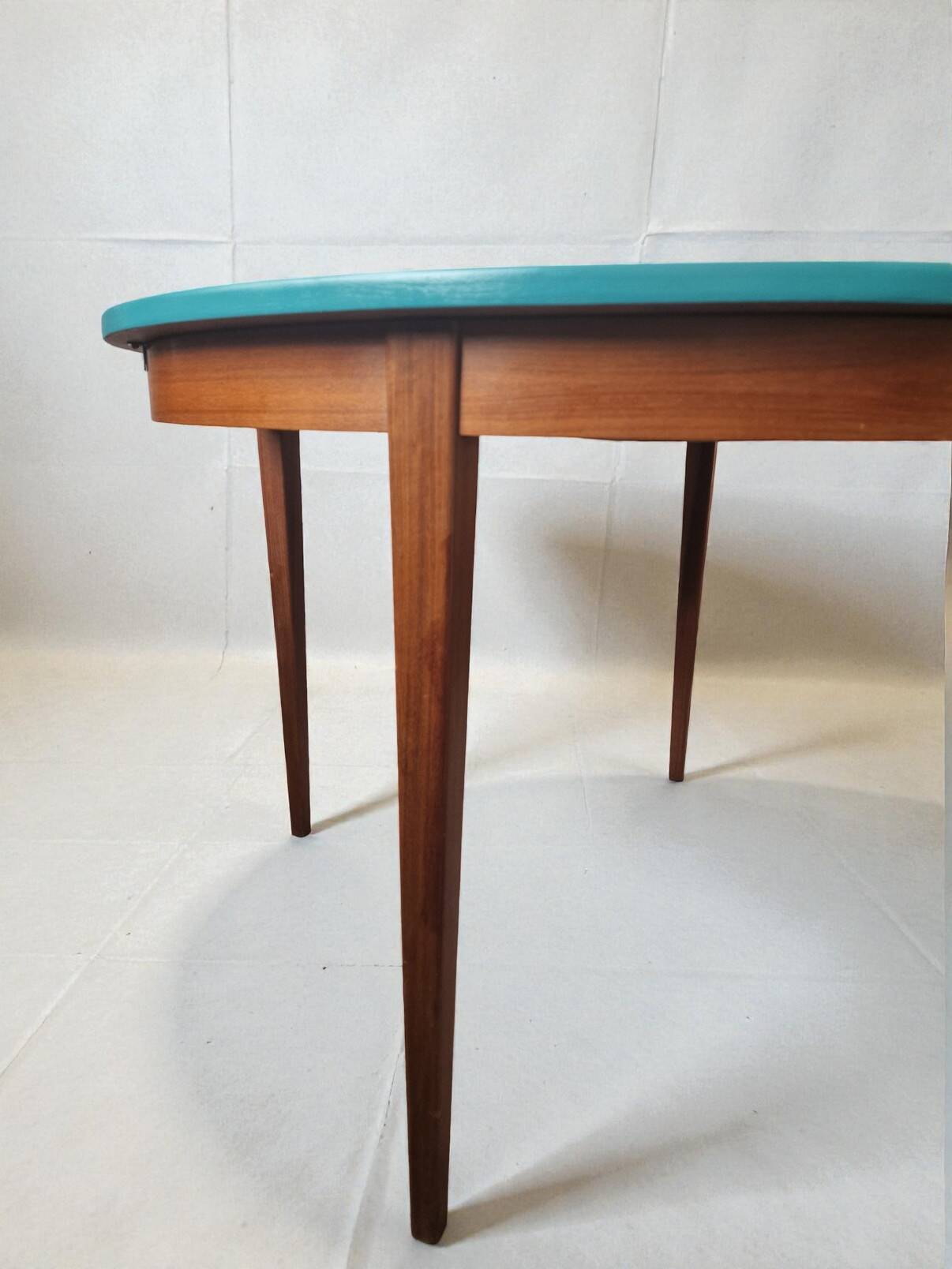 Extendable oval teak dining table