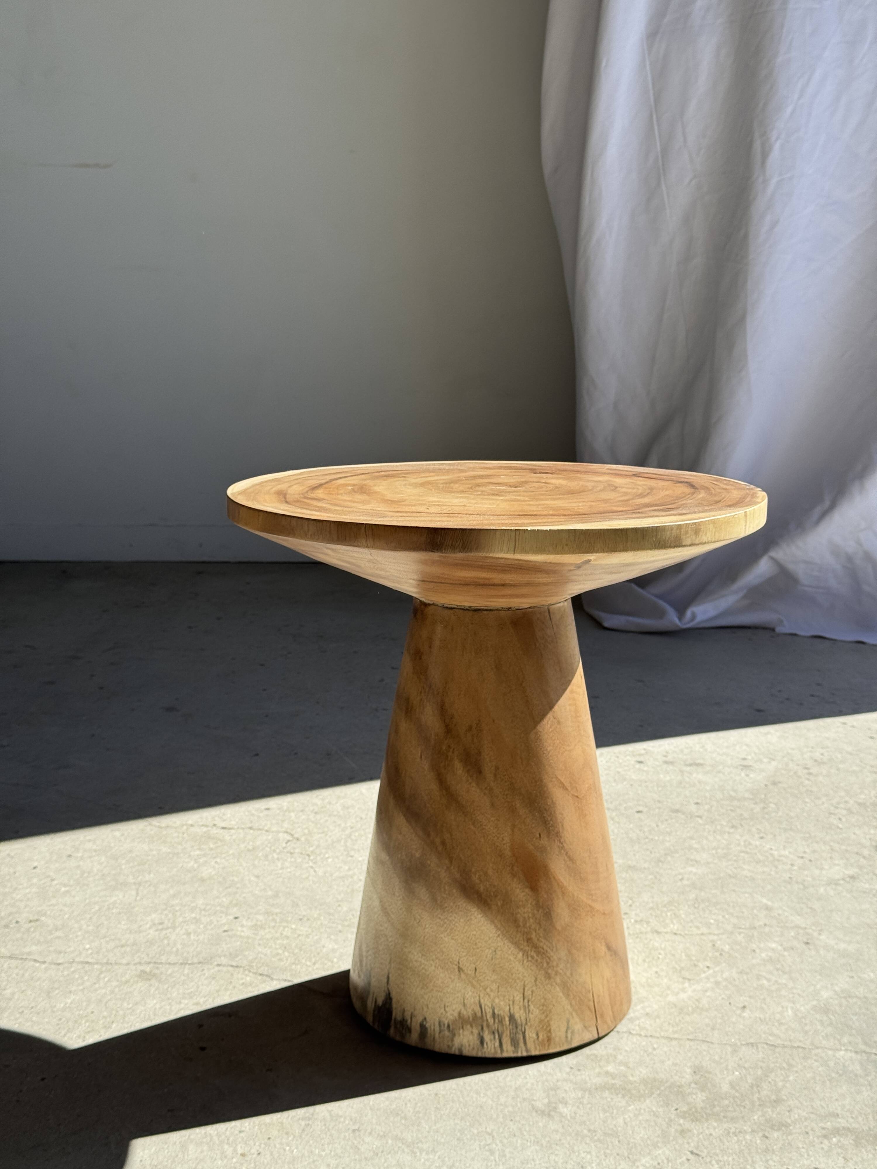 Natural solid suar side table (monoxyle) with a minimal conical base.