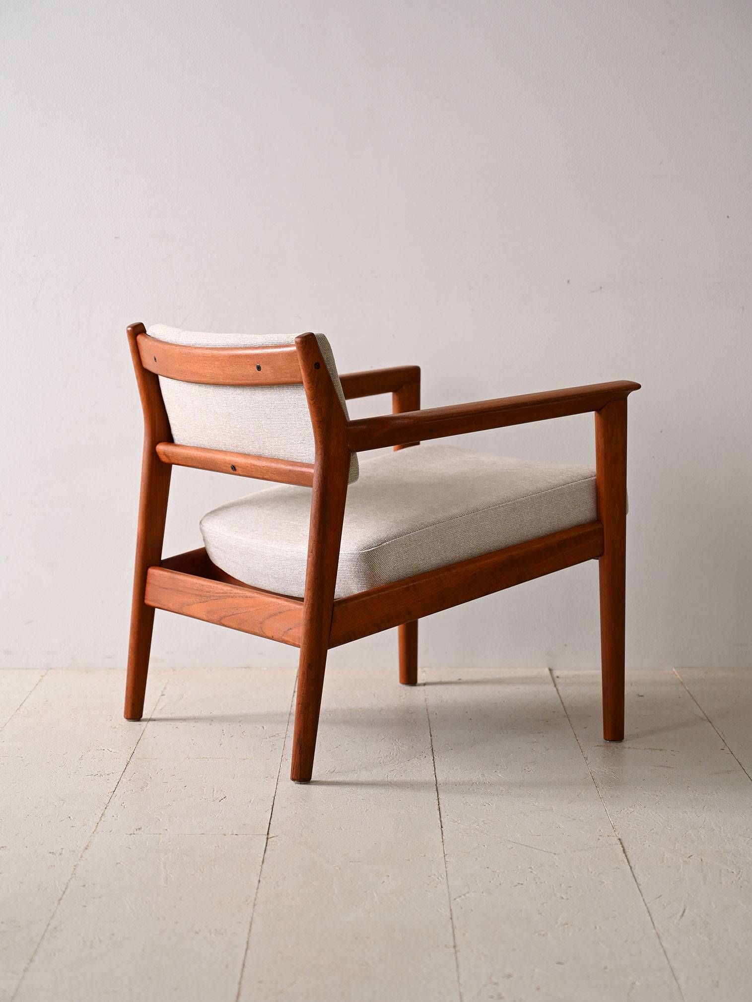 Upholstered armchair with teak frame