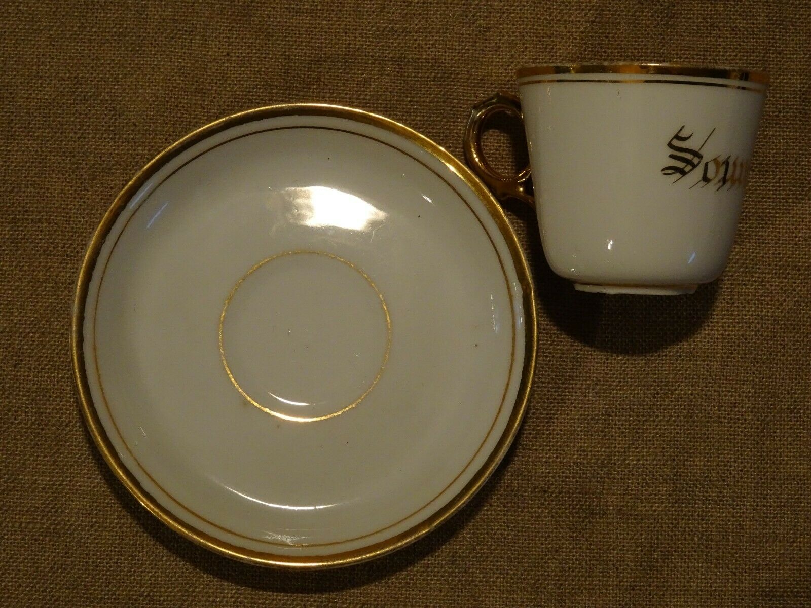 Old white and gold porcelain mocha cup marked souvenir