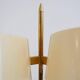 Brass and lacquered metal floor lamp with a wooden magazine shelf.