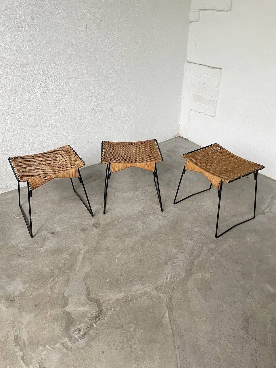 Set of three Raoul Guys wicker and metal stools