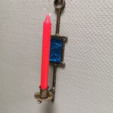 Wall-mounted candle holder in cast iron and hard pressed blue glass.