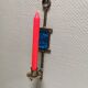 Wall-mounted candle holder in cast iron and hard pressed blue glass.