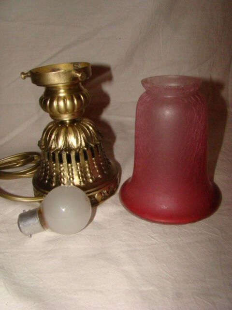 bronze bedside lamp with a pink cracked glass shade
