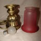 bronze bedside lamp with a pink cracked glass shade